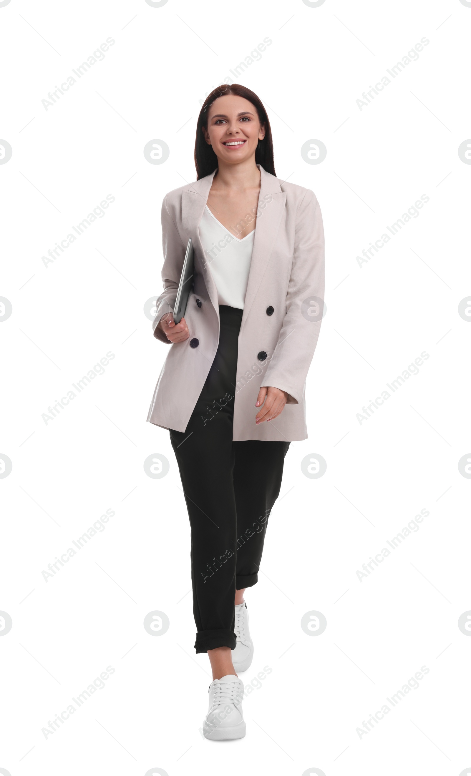 Photo of Beautiful businesswoman in suit with laptop walking on white background