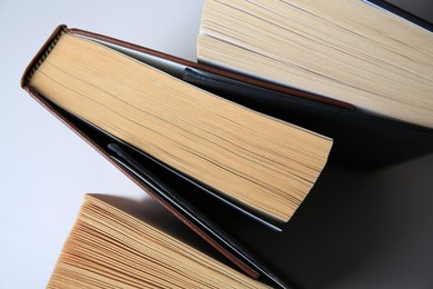 Collection of different books on white shelf, above view