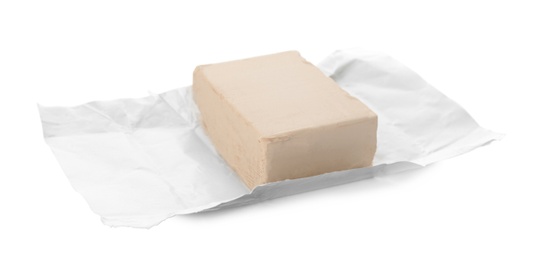 Unwrapped block of compressed yeast on white background