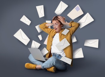 Image of Email spam. Emotional young woman with laptop and many letters on grey background