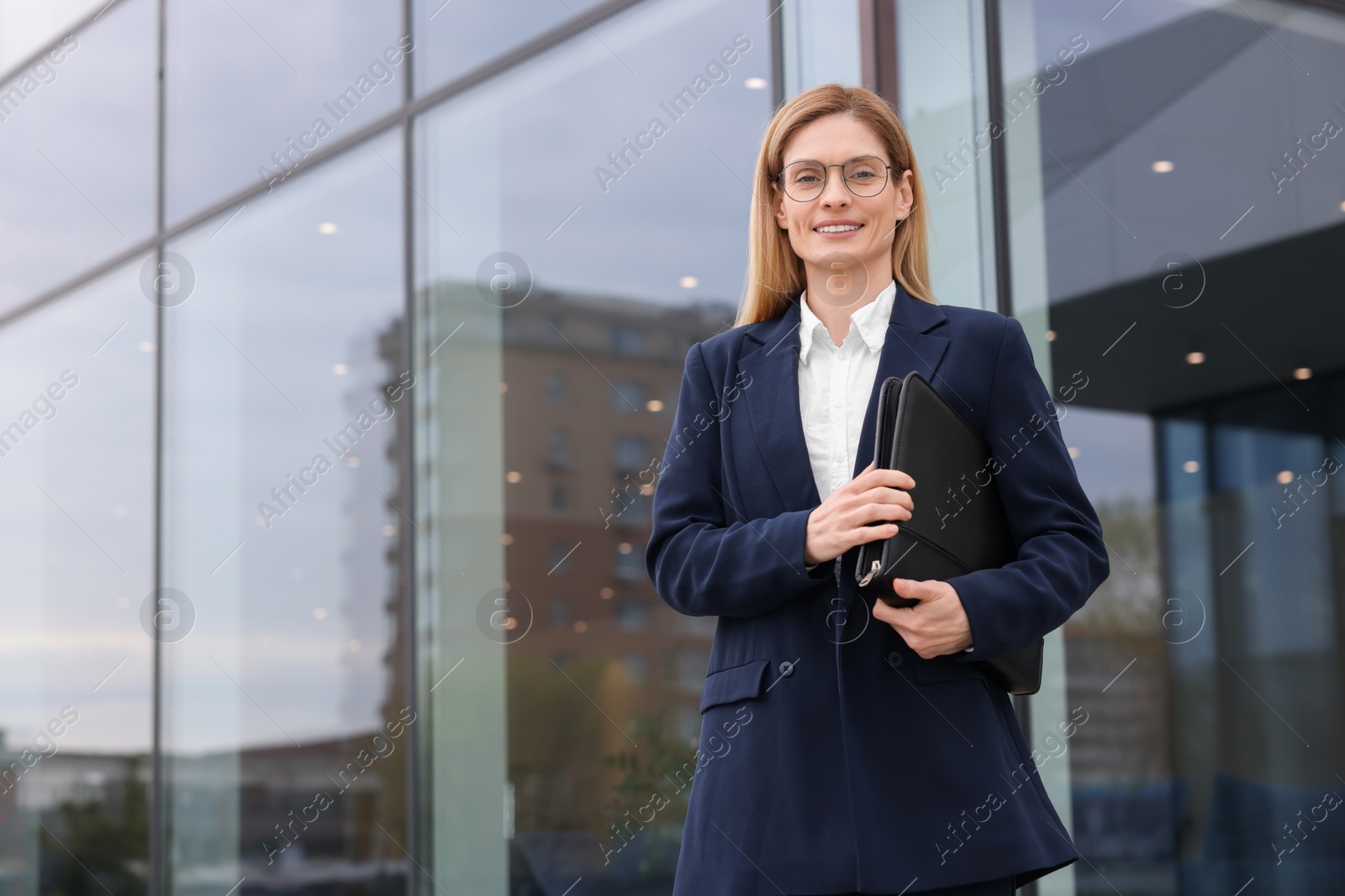 Photo of Real estate agent with leather portfolio outdoors. Space for text