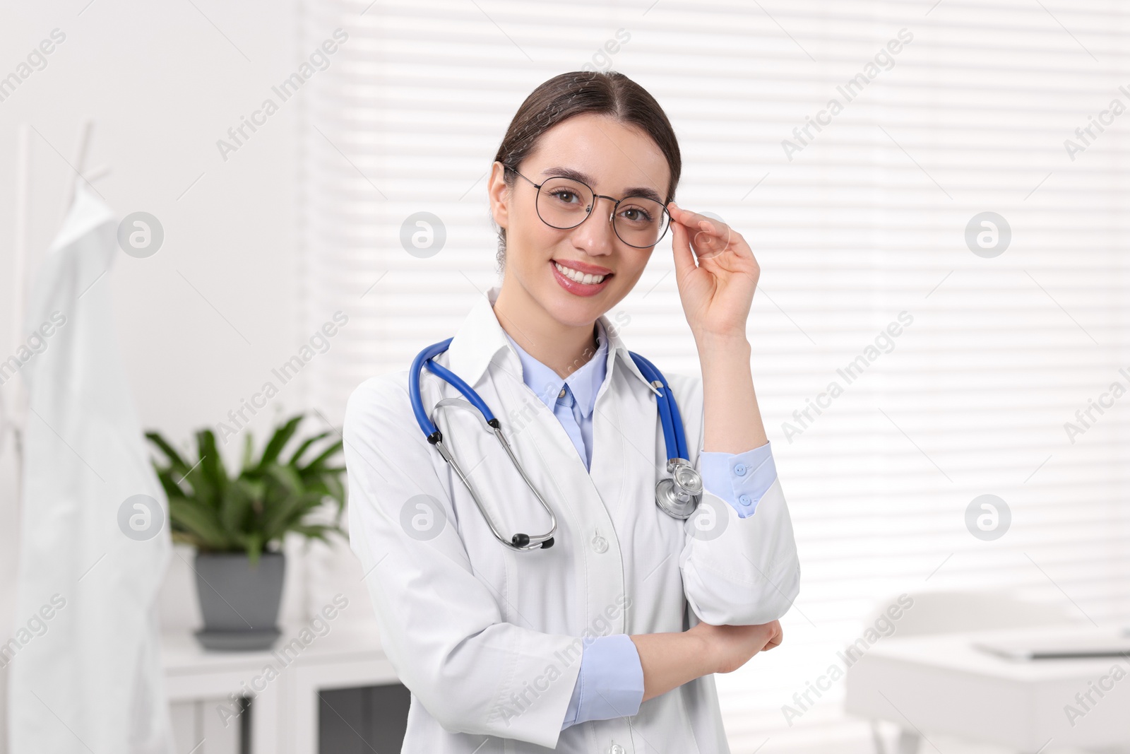 Photo of Medical consultant with glasses and stethoscope in clinic