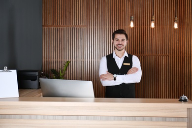 Portrait of receptionist at desk in lobby