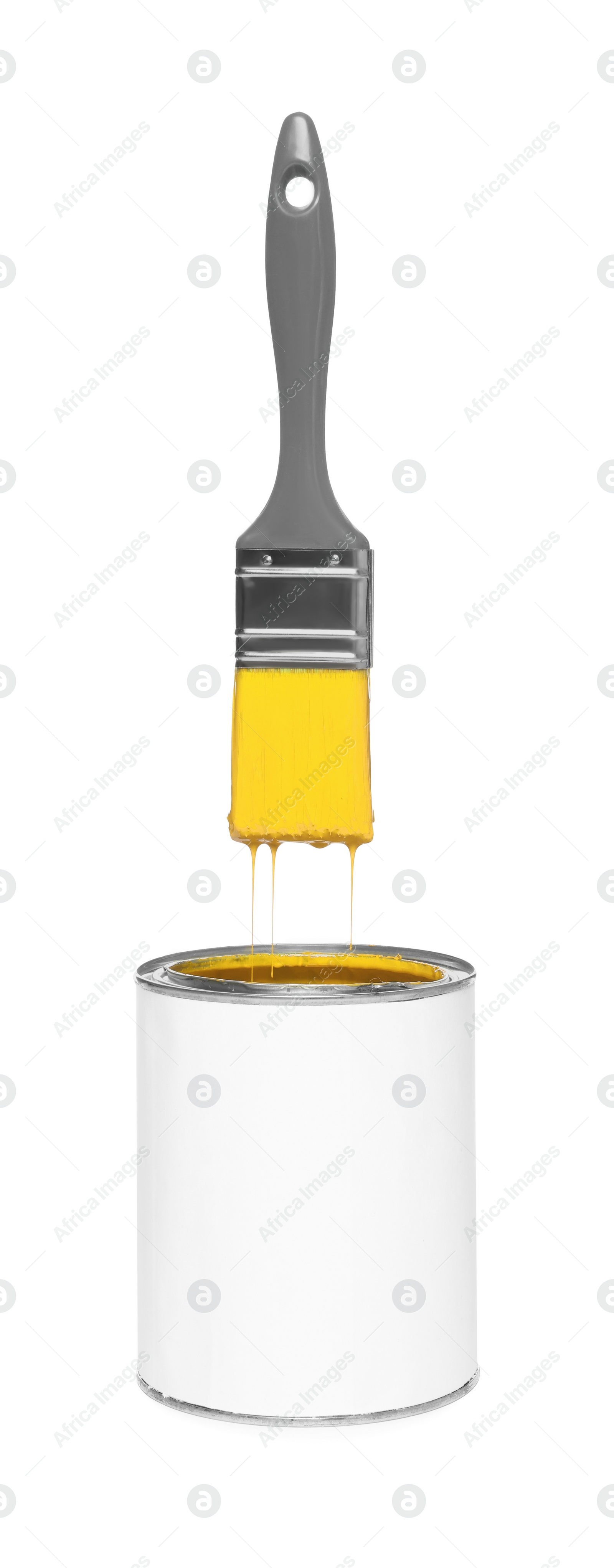 Image of Brush with yellow paint in air over can on white background