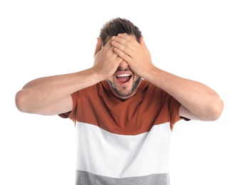 Man covering eyes while being blinded on white background