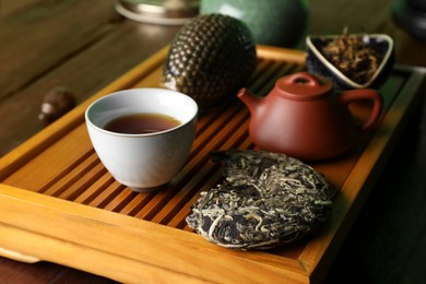Photo of Traditional tea ceremony arrangement on wooden table, closeup