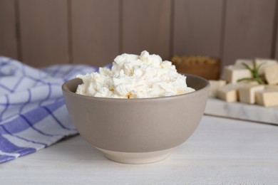 Photo of Delicious tofu cream cheese in bowl on white wooden table