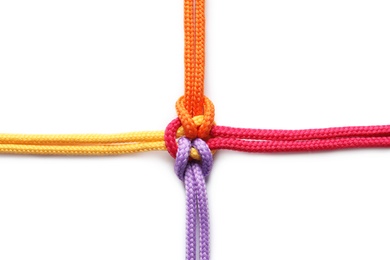 Photo of Colorful ropes tied together on white background. Unity concept