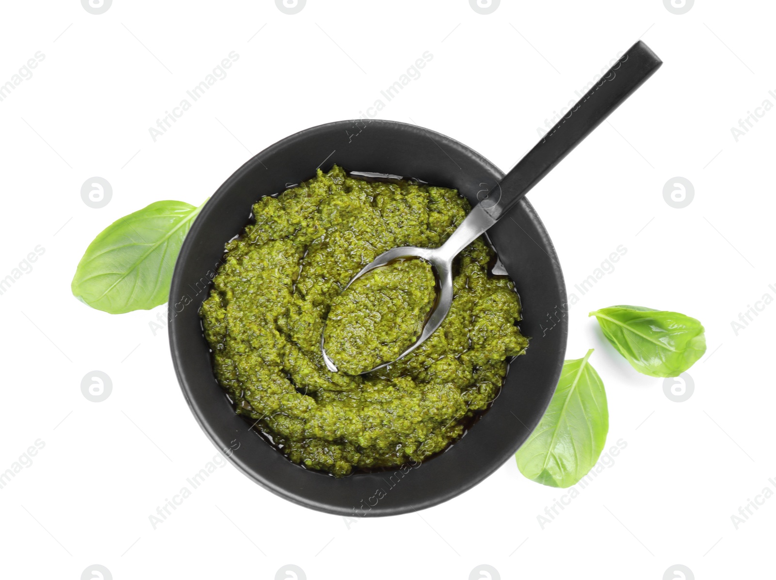 Photo of Fresh tasty pesto sauce and basil isolated on white, top view