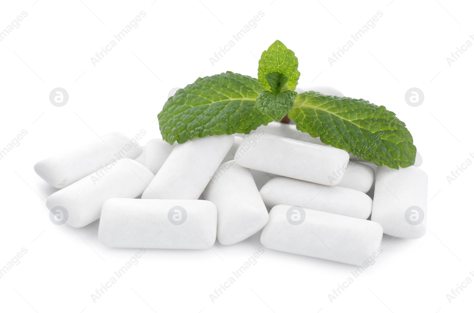 Photo of Heap of chewing gum pieces and mint on white background