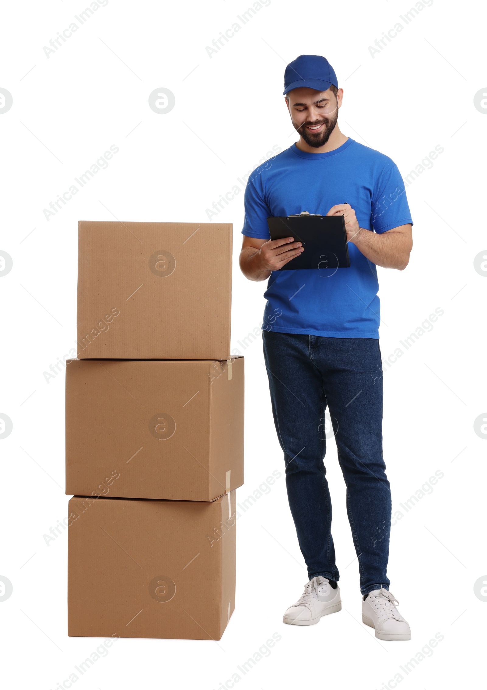 Photo of Happy young courier with stack of parcels and clipboard on white background