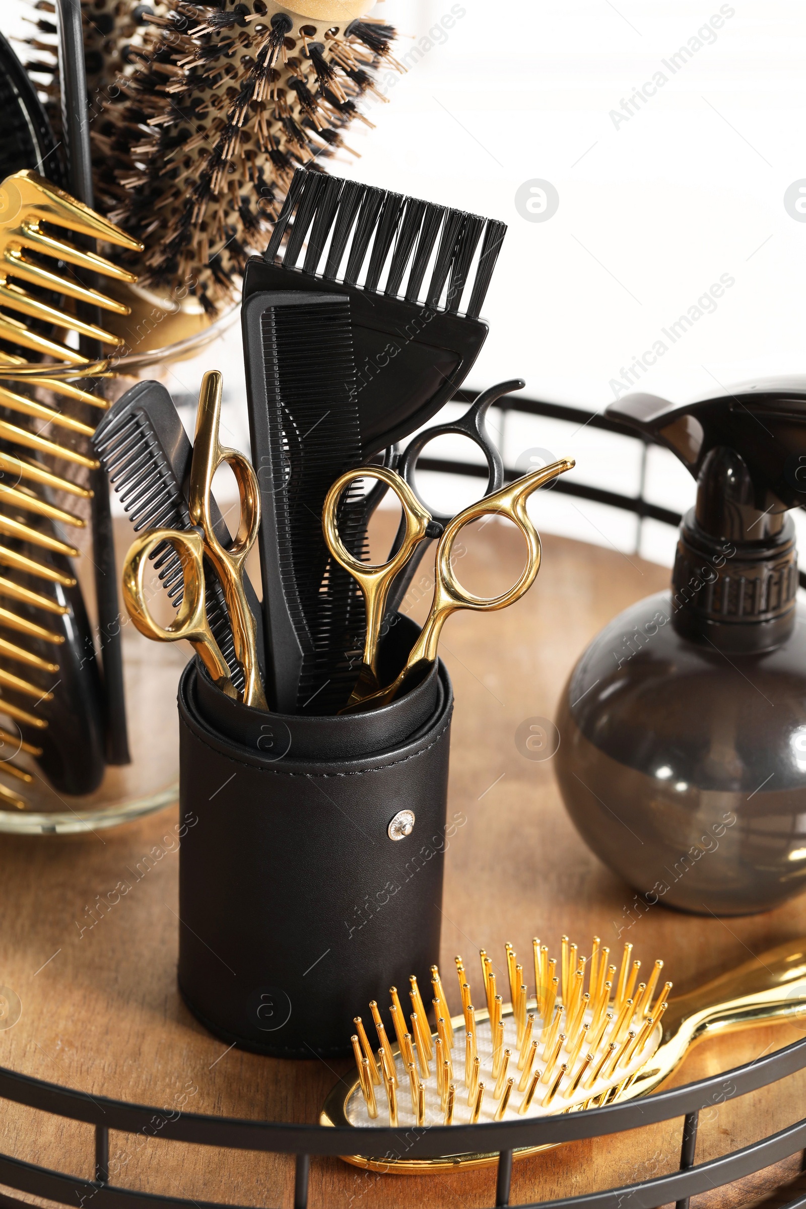 Photo of Set of hairdresser tools on table in salon