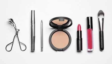 Set of makeup products on white background, top view