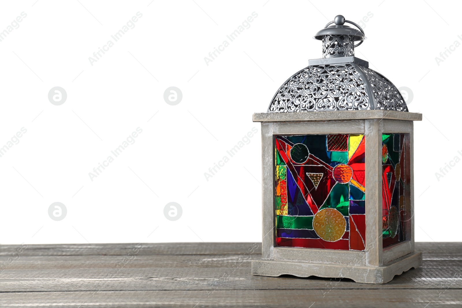 Photo of Decorative Arabic lantern on wooden table against white background