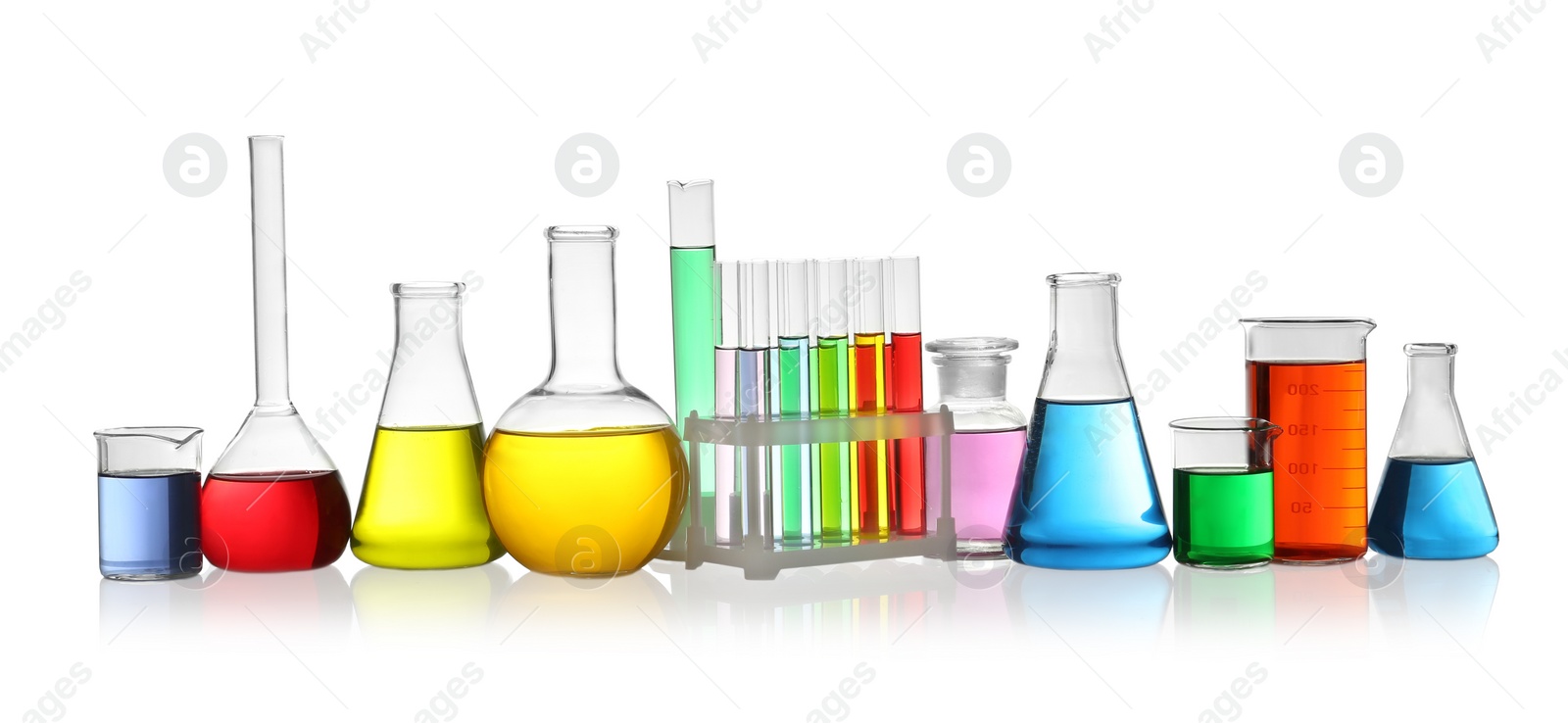 Photo of Laboratory glassware with colorful liquids on white background