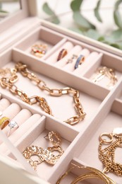 Photo of Jewelry box with stylish golden bijouterie, closeup view
