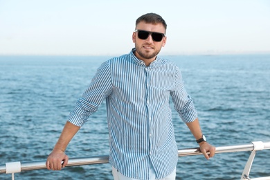 Portrait of handsome young man on sea pier