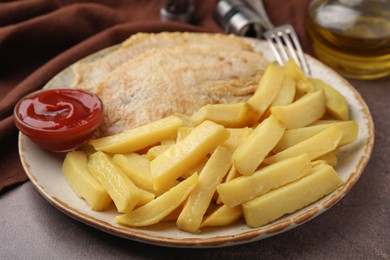 Photo of Delicious fish and chips with ketchup served on brown table, closeup