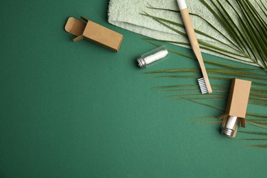 Flat lay composition with natural dental floss on green background. Space for text