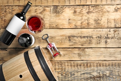 Photo of Glassware with red wine on wooden background, top view