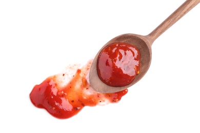 Photo of Wooden spoon and red sauce on white background, top view