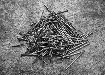 Photo of Many metal nails on grey background, flat lay