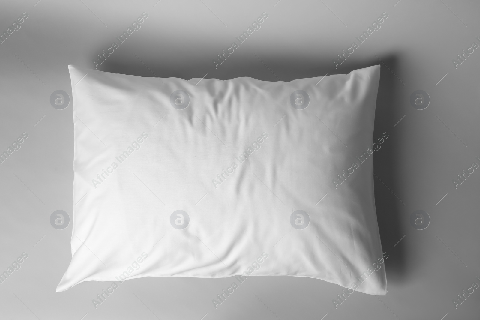 Photo of Blank soft pillow on light background