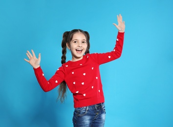 Photo of Portrait of emotional little girl posing on color background