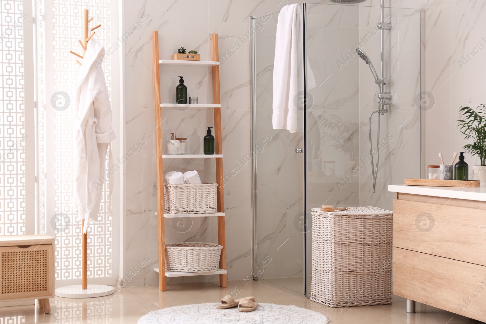 Photo of Modern bathroom interior with decorative ladder and shower stall