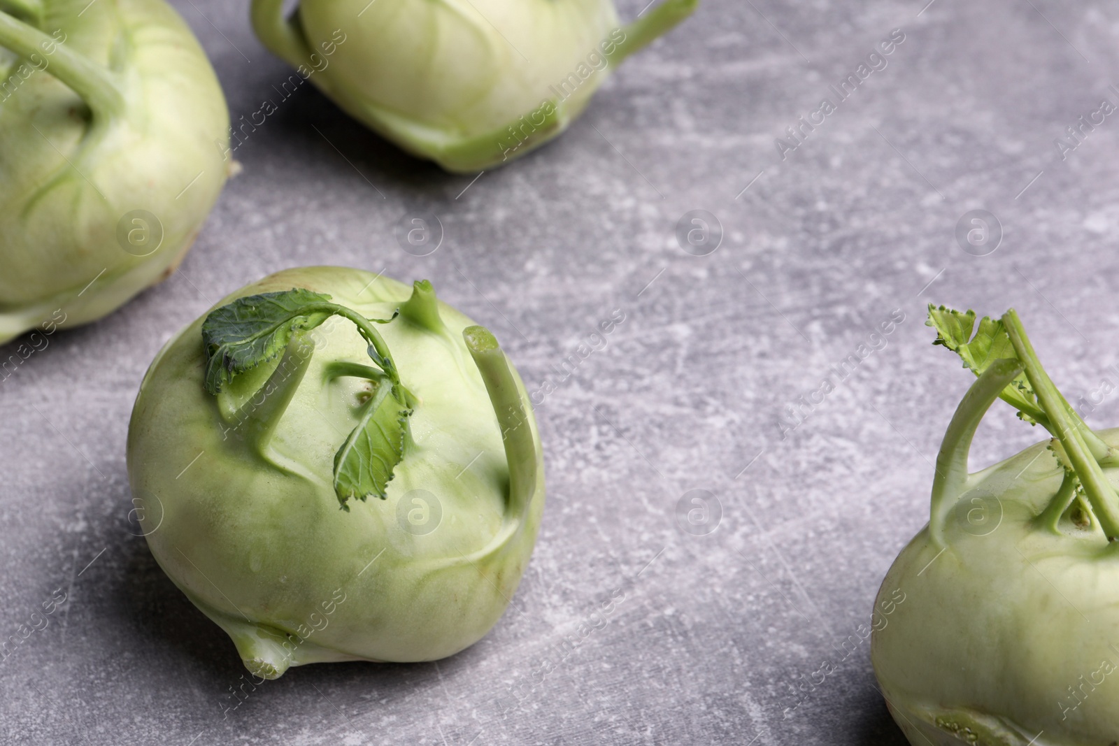 Photo of Whole ripe kohlrabi plants on grey table