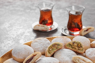 Traditional cookies for Islamic holidays and tea on table. Eid Mubarak