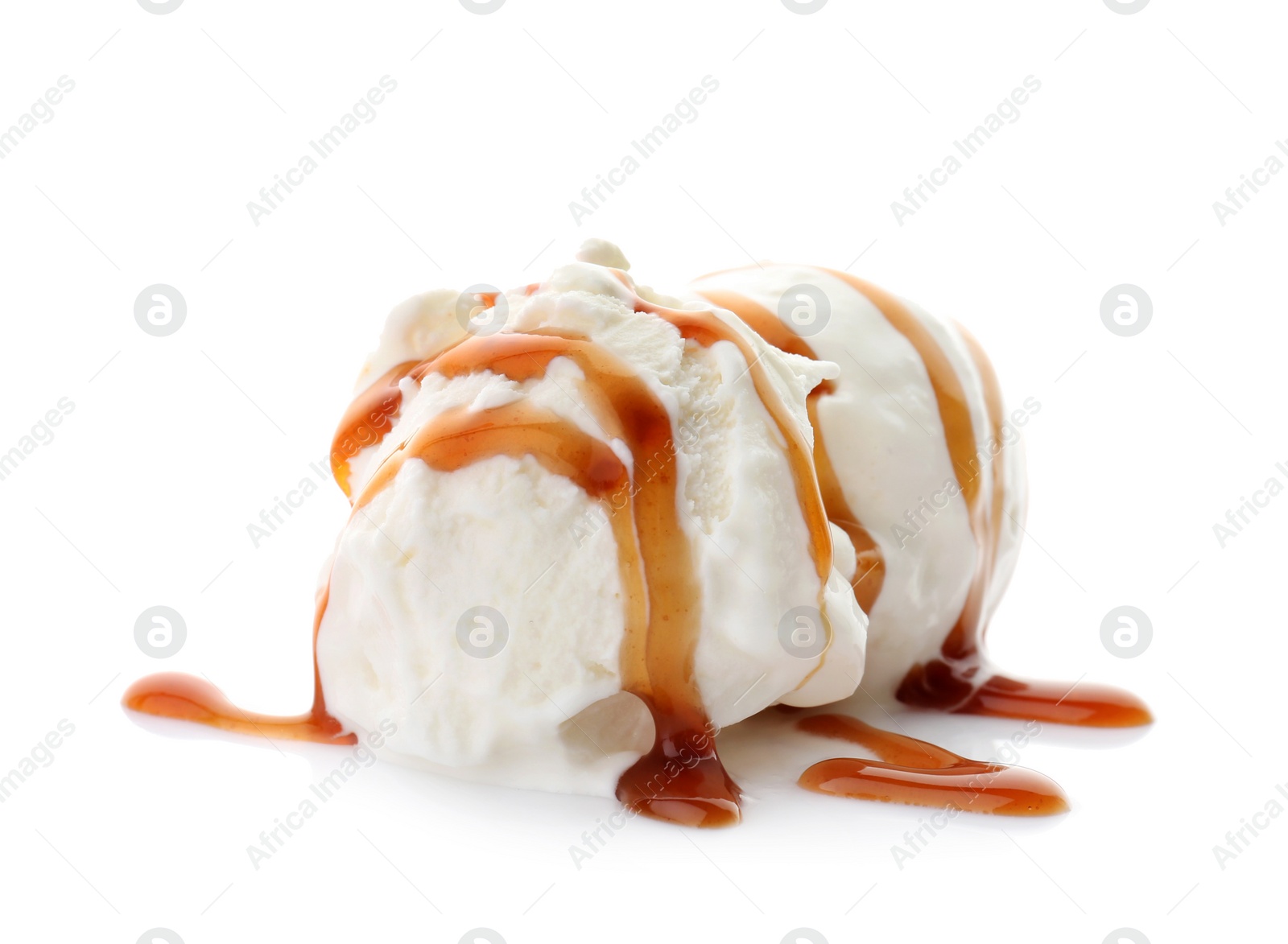 Photo of Balls of tasty vanilla ice cream with caramel topping on white background