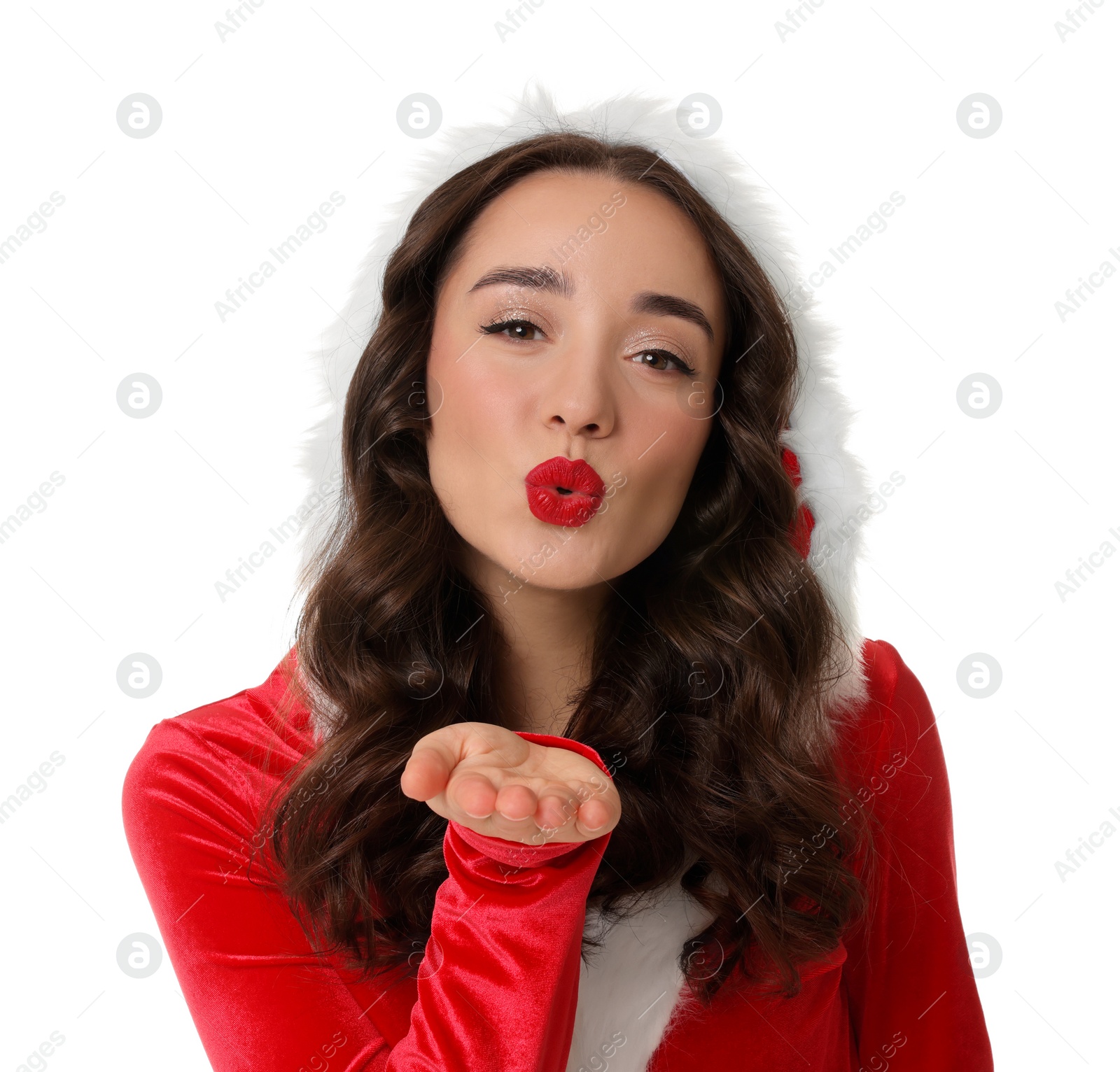 Photo of Beautiful young woman in Christmas red dress blowing kiss on white background