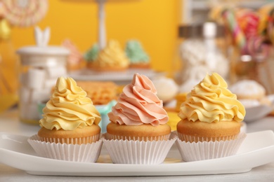 Photo of Tasty cupcakes and other sweets on table. Candy bar, closeup view