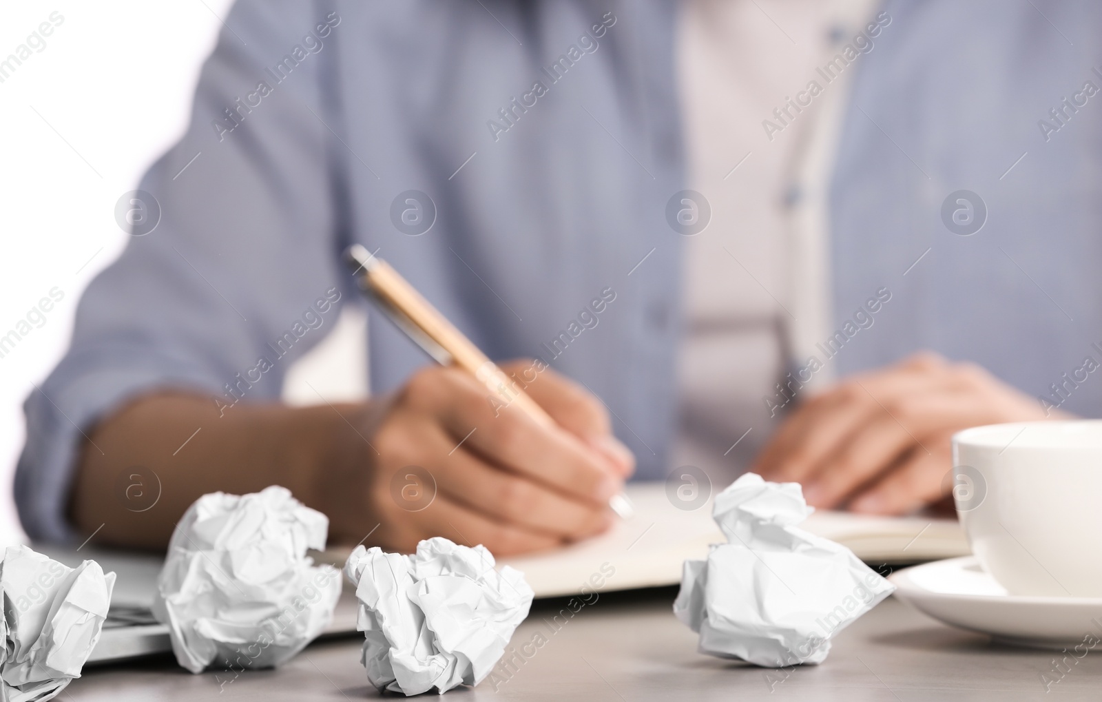 Photo of Woman working at table with crumpled paper, closeup. Generating idea