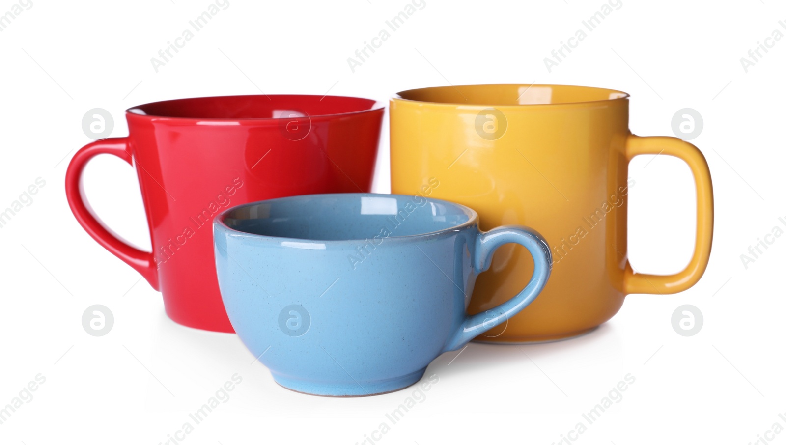 Photo of Set of colorful cups on white background