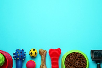 Photo of Pet toys, food and brush on light blue background, flat lay. Space for text