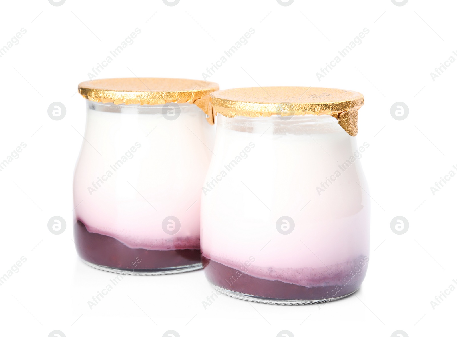 Photo of Glass jars of tasty fruit yogurt on white background