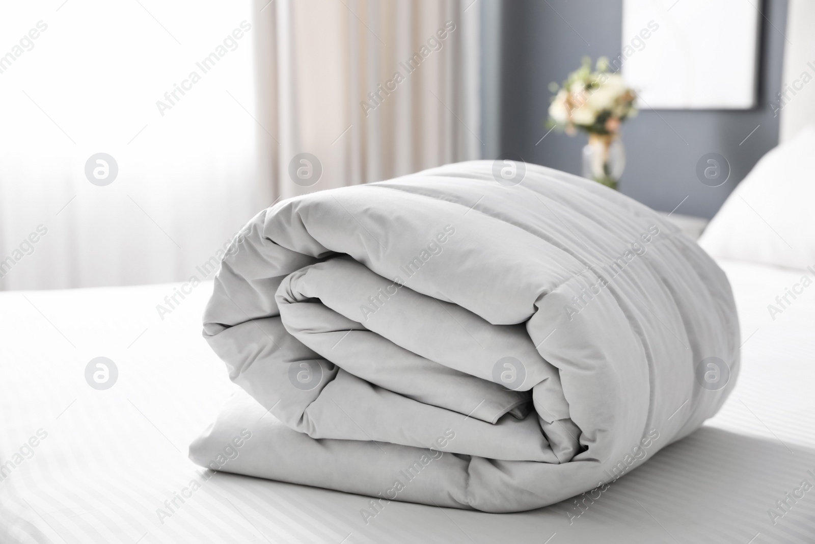 Photo of Soft folded blanket on bed at home