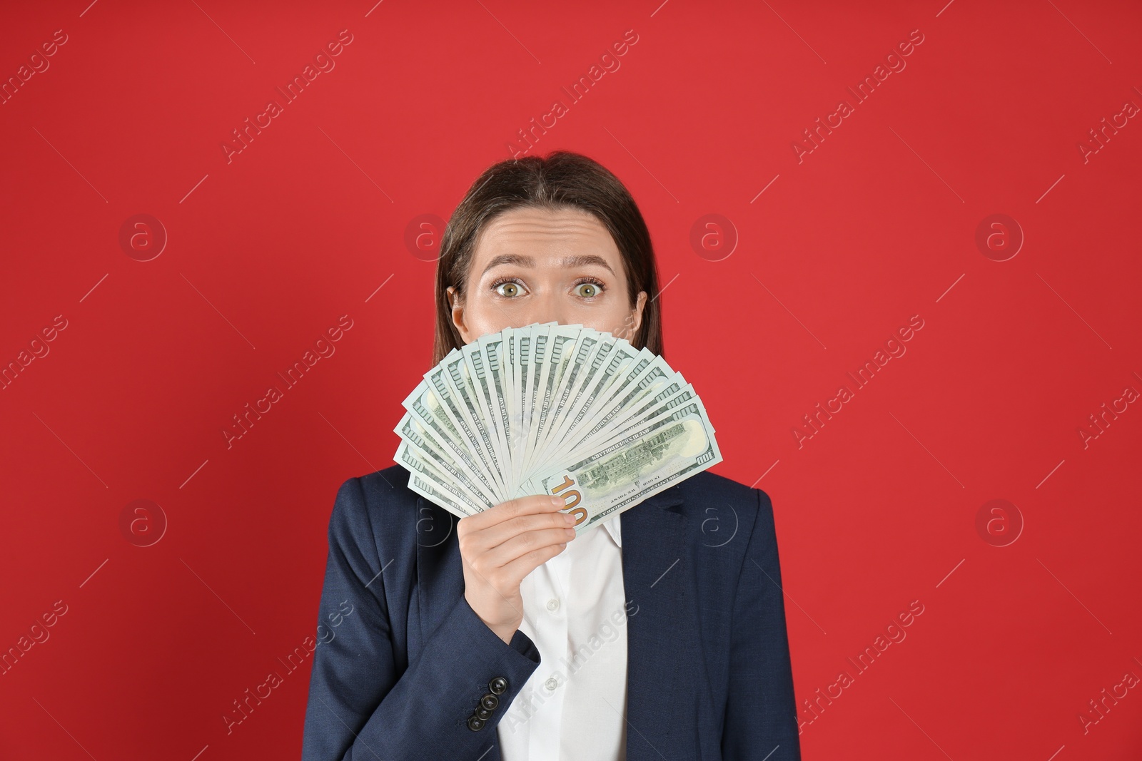 Photo of Young woman with money on crimson background