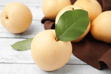 Photo of Delicious apple pears on white wooden table