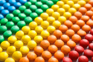 Photo of Many small colorful candies as background, closeup