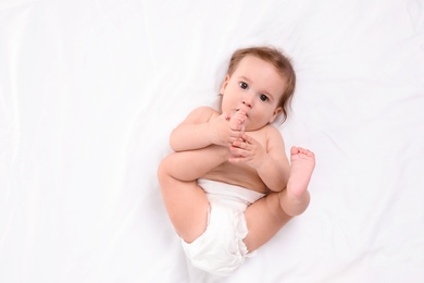 Cute little baby lying on white background, top view