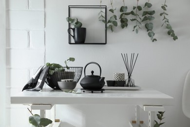 Stylish room decorated with beautiful green eucalyptus branches