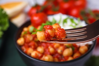 Fork with delicious chickpea curry, closeup view