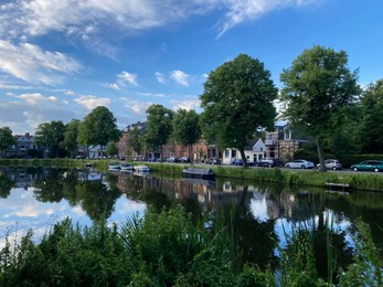 Photo of Beautiful view of street near river with moored boats