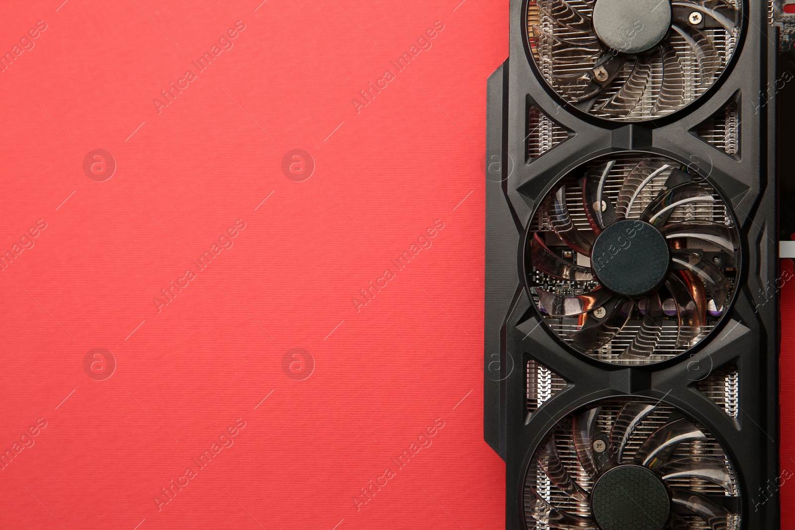 Photo of One graphics card on red background, top view. Space for text