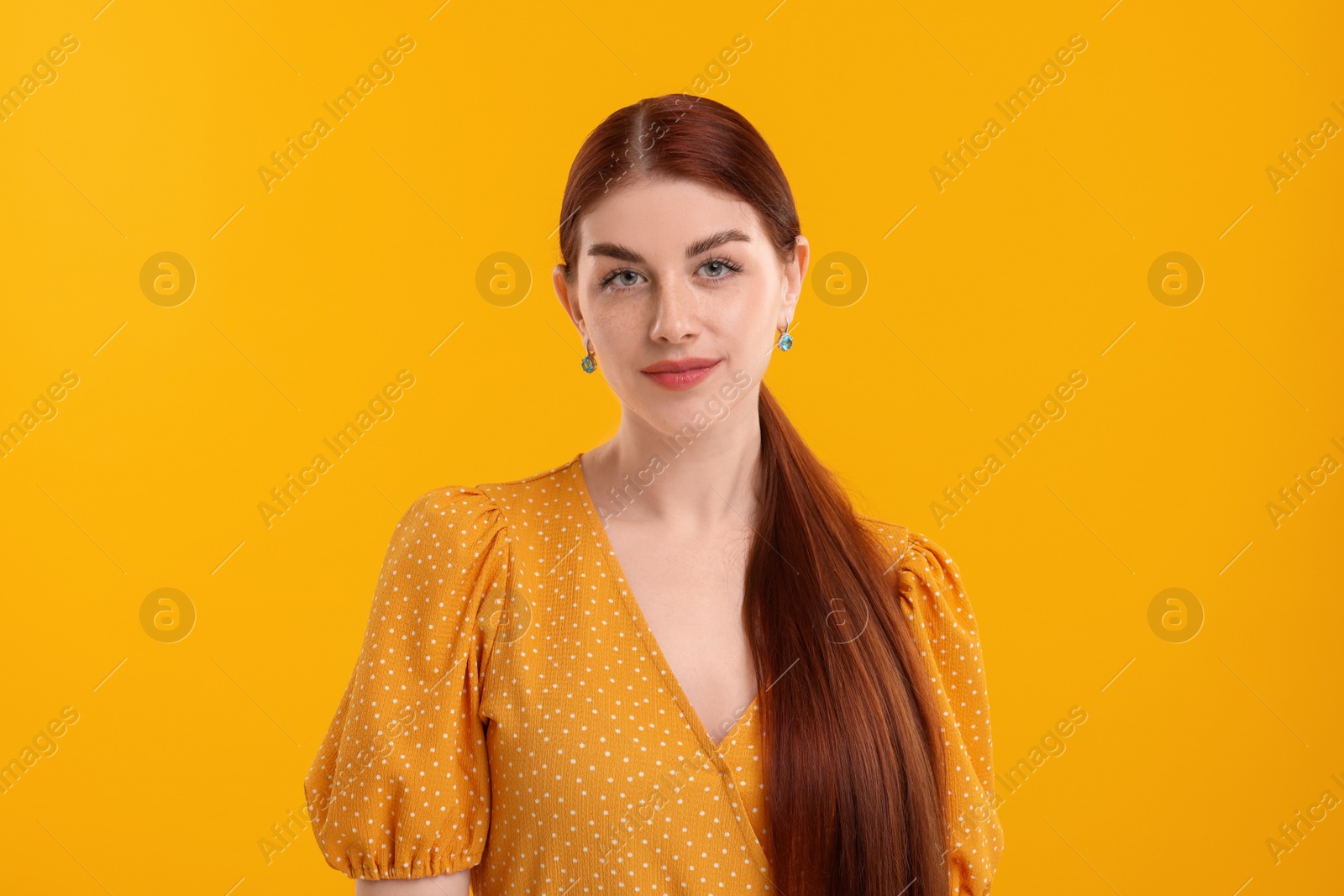 Photo of Portrait of beautiful woman on yellow background