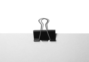 Photo of Paper with black binder clip isolated on white
