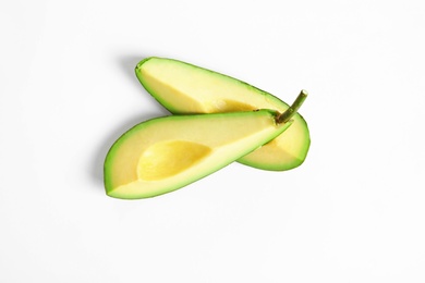 Slices of avocado on white background